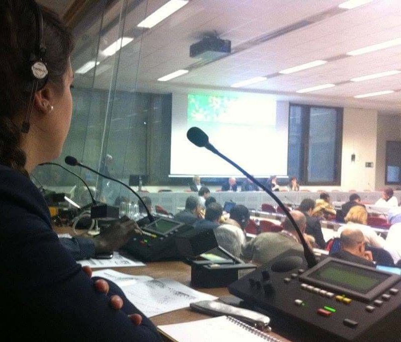 Simultaneous interpreters working at a multilingual conference